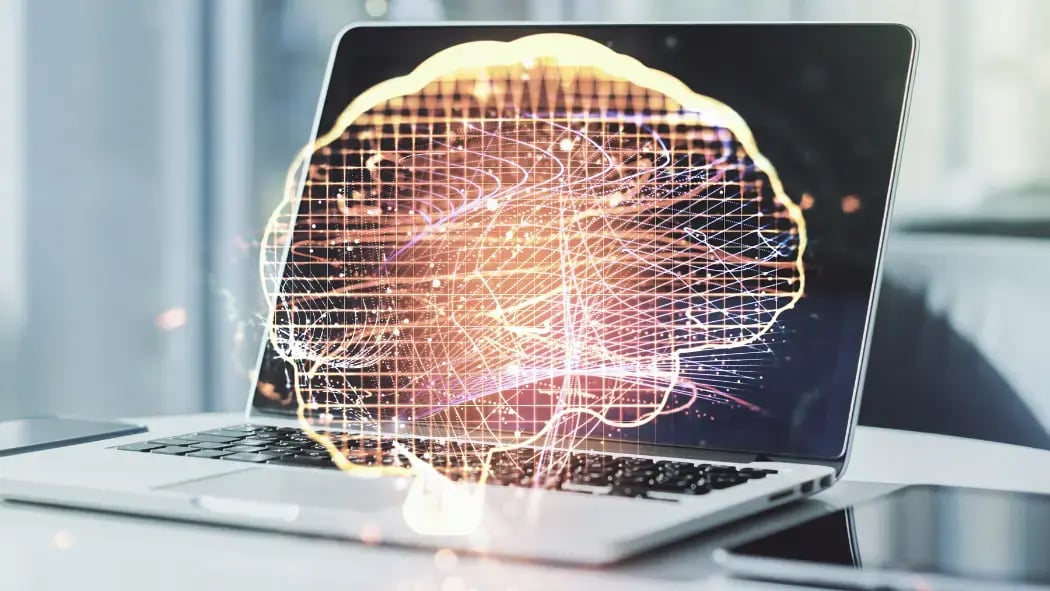 A laptop showing a digital image of a brain