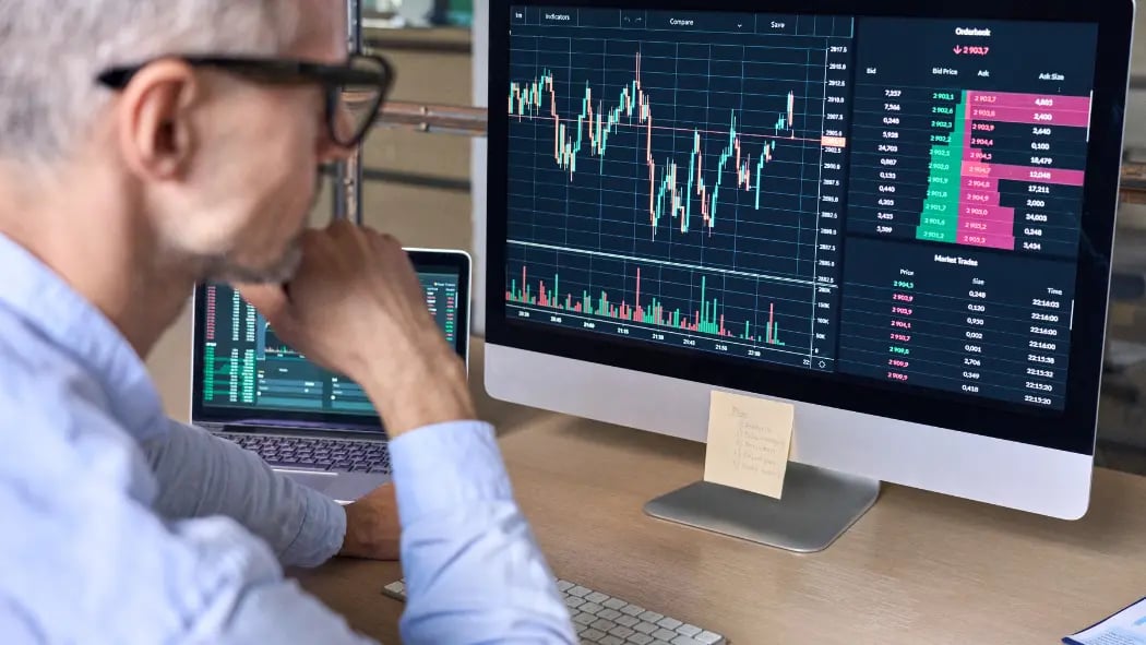 Man sat at desk looking at data on a screen