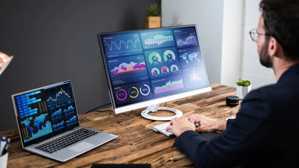 Man sat at computer screens showing data