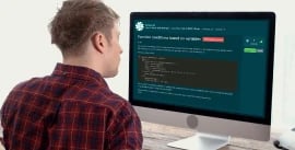 A white man sitting at a desk in front of a screen with EDUKATE.AI learning platform displayed