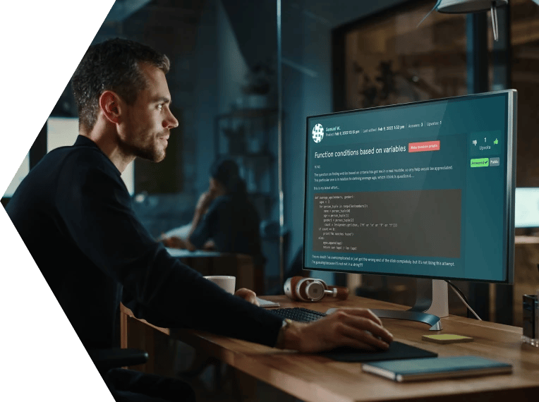 Man around 35 years old sat at a desk in front of a computer screen showing EDUKATE.AI learning platform