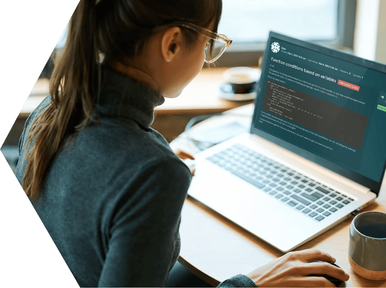 Young woman sat in front of a computer screen showing the EDUKATE.AI learning platform