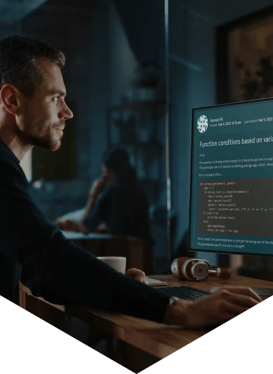 Man around 35 years old sat at a desk in front of a computer screen showing EDUKATE.AI learning platform