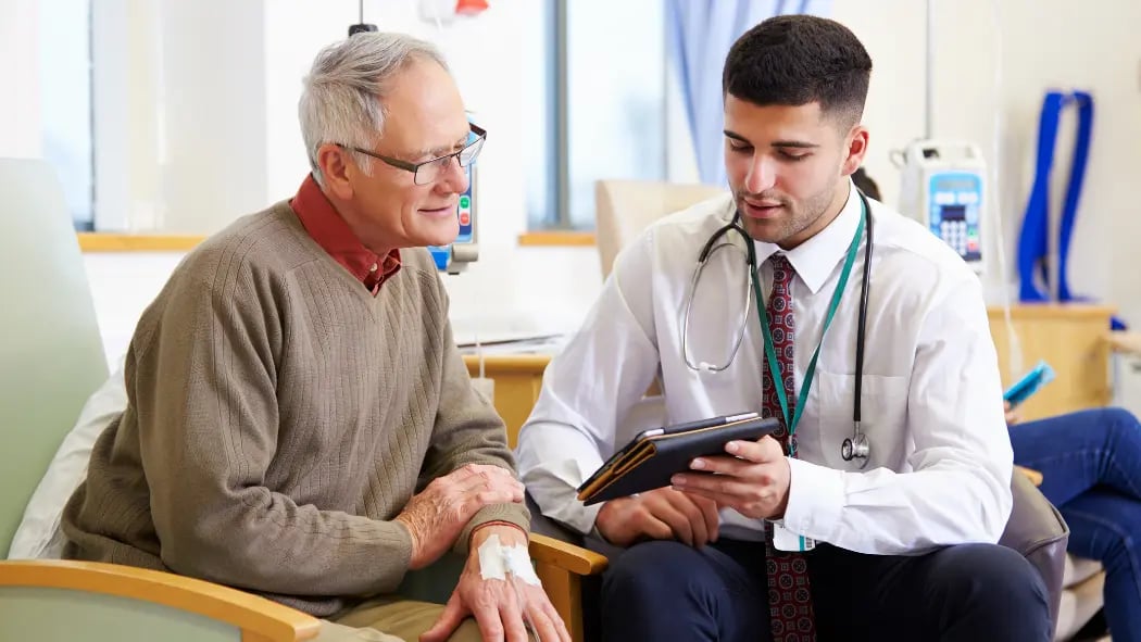 Healthcare professional talking to an elderly patient