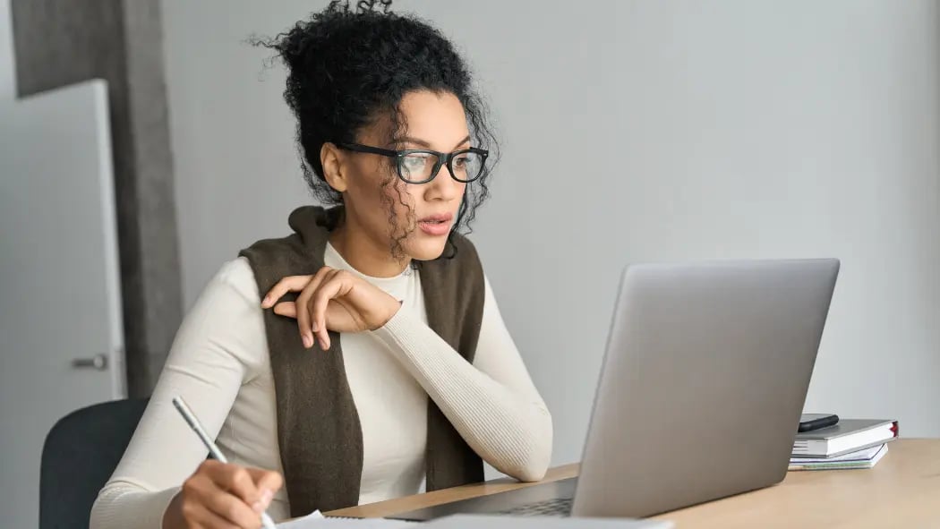 Woman sat learning at laptop