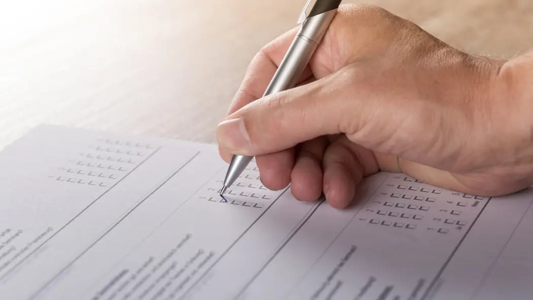 A hand writing on a survey