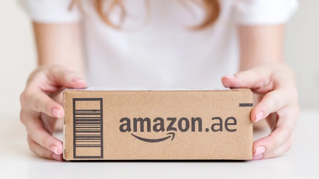 Hands holding an Amazon box