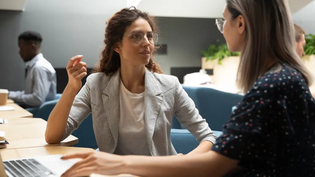 2 women in an office talking