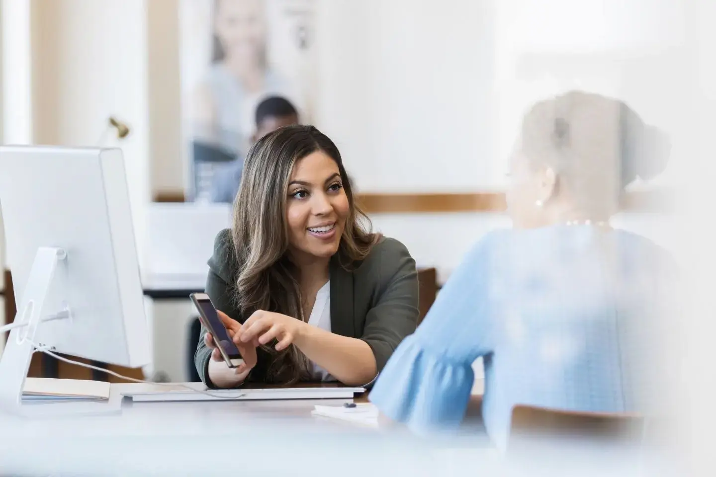 Working professional showing a colleague new insights in AI