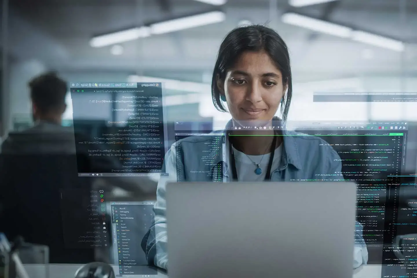 A person looking into laptop screen with overlay of code
