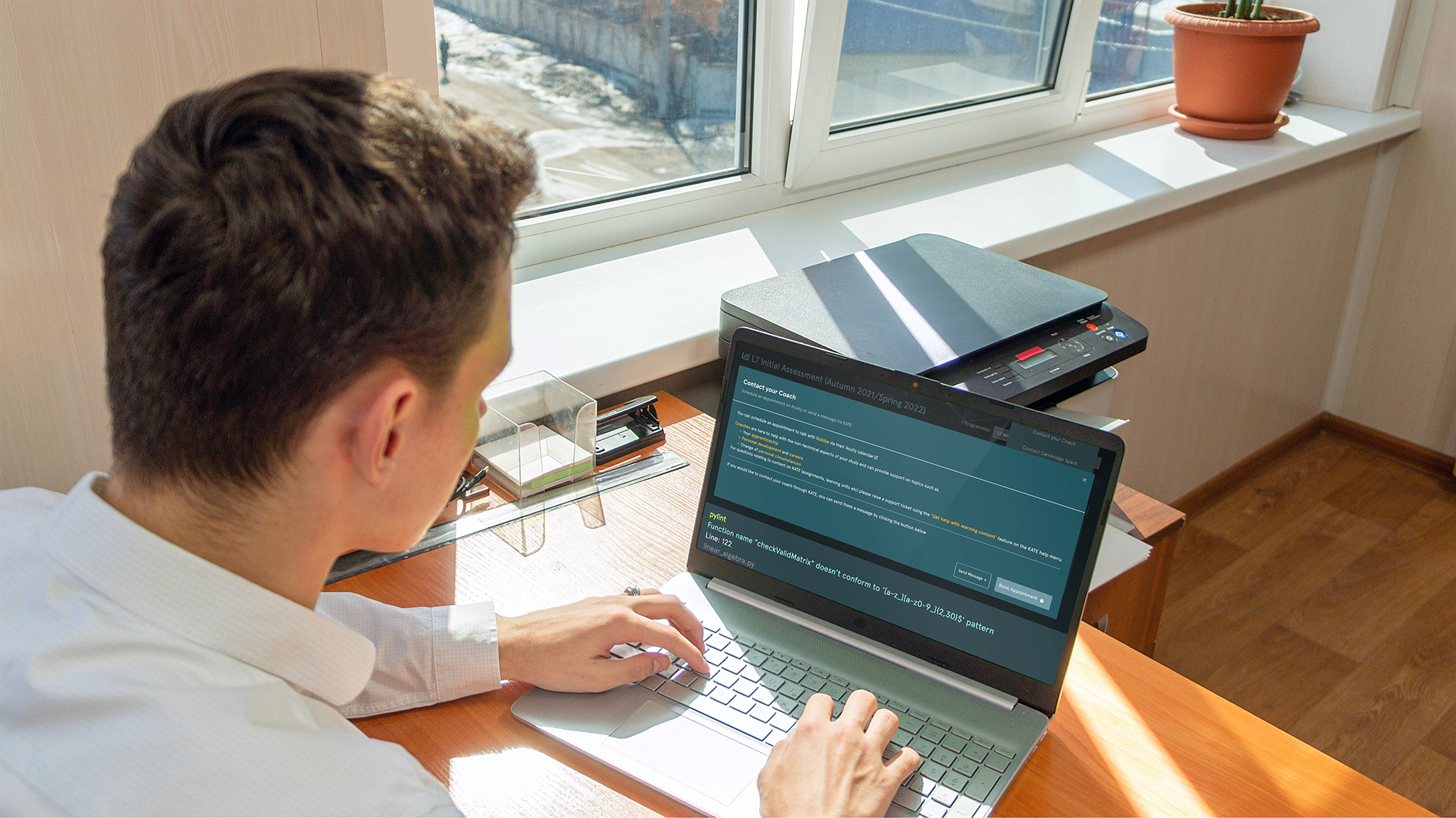 Man sitting at laptop with EDUKATE.AI learning platform on display