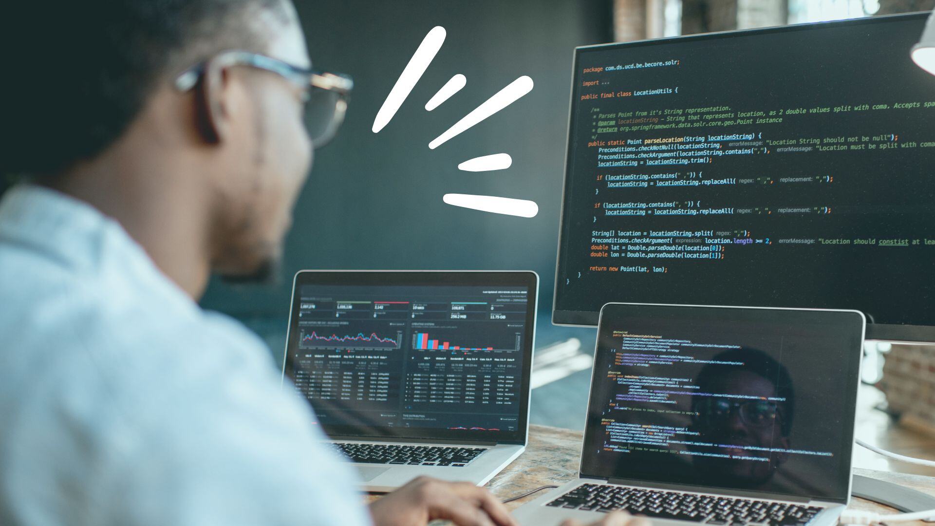 Professional looks at a few screens with code on
